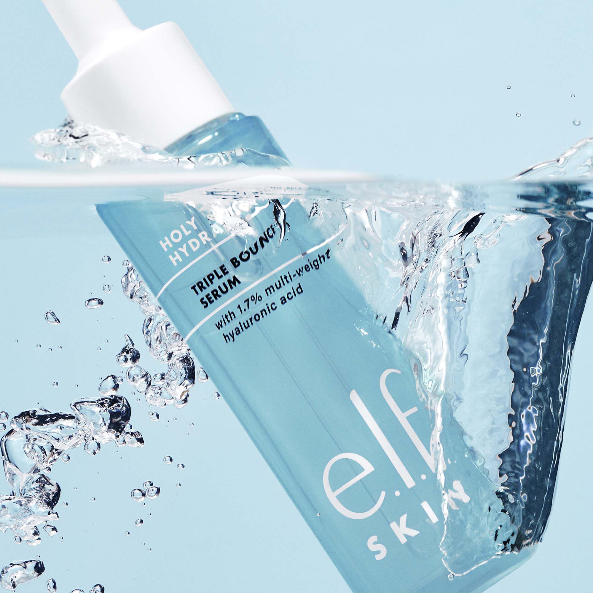 e.l.f. Skin Holy Hydrant serum bottle with water splash on a light blue background