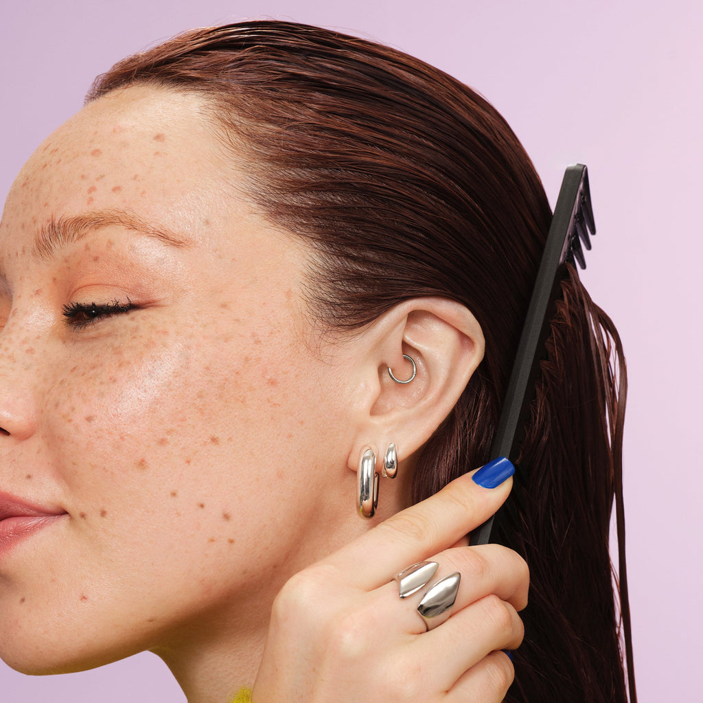 Woman combing in 3-in Wonder Magic Styling Cream Through Her Hair