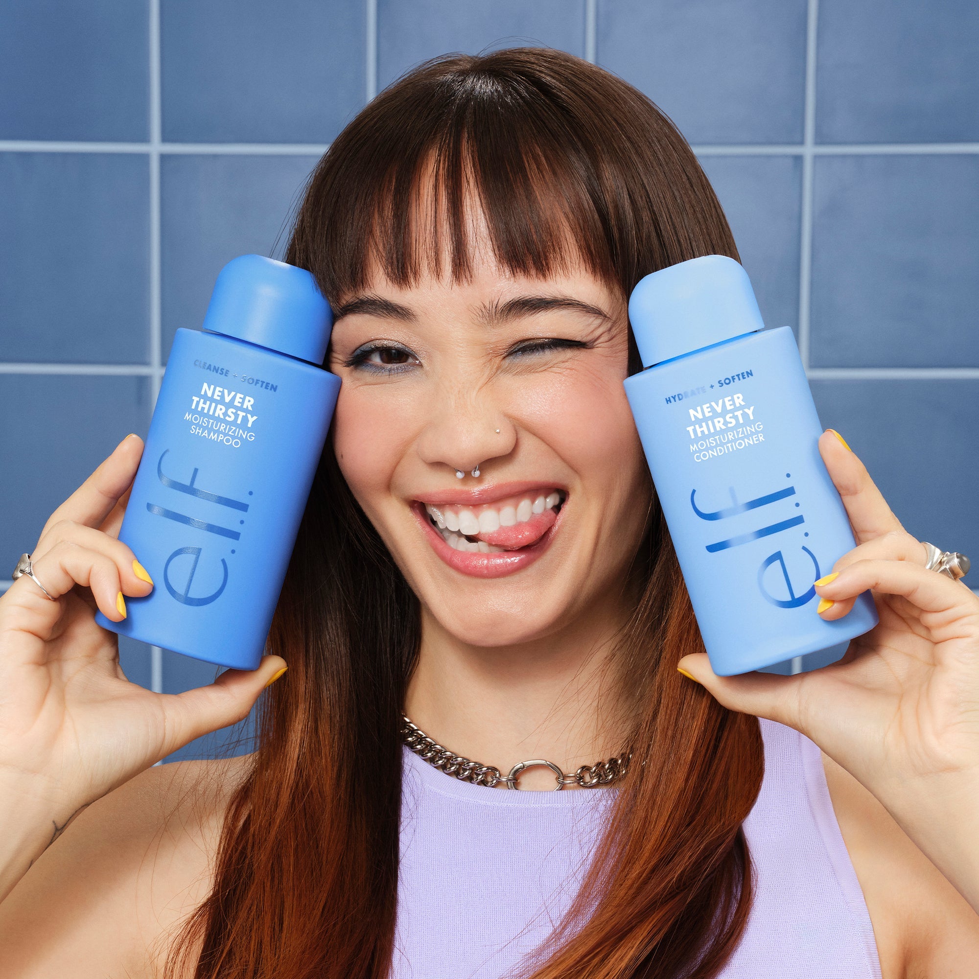 Woman holding Never Thirsty Moisturizing Shampoo and Conditioner by e.l.f.