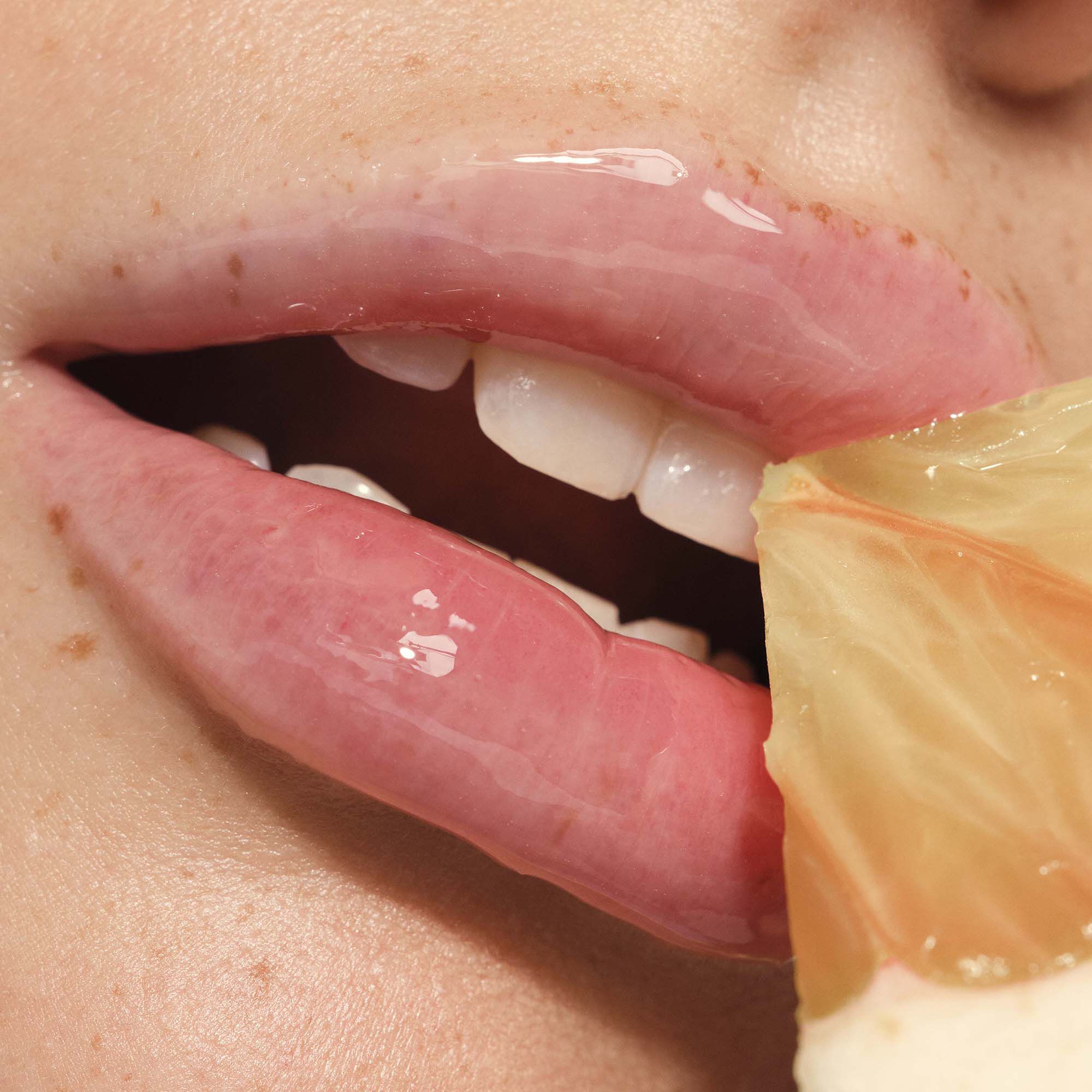 Woman Wearing Clear Pomelo Lip Treatment