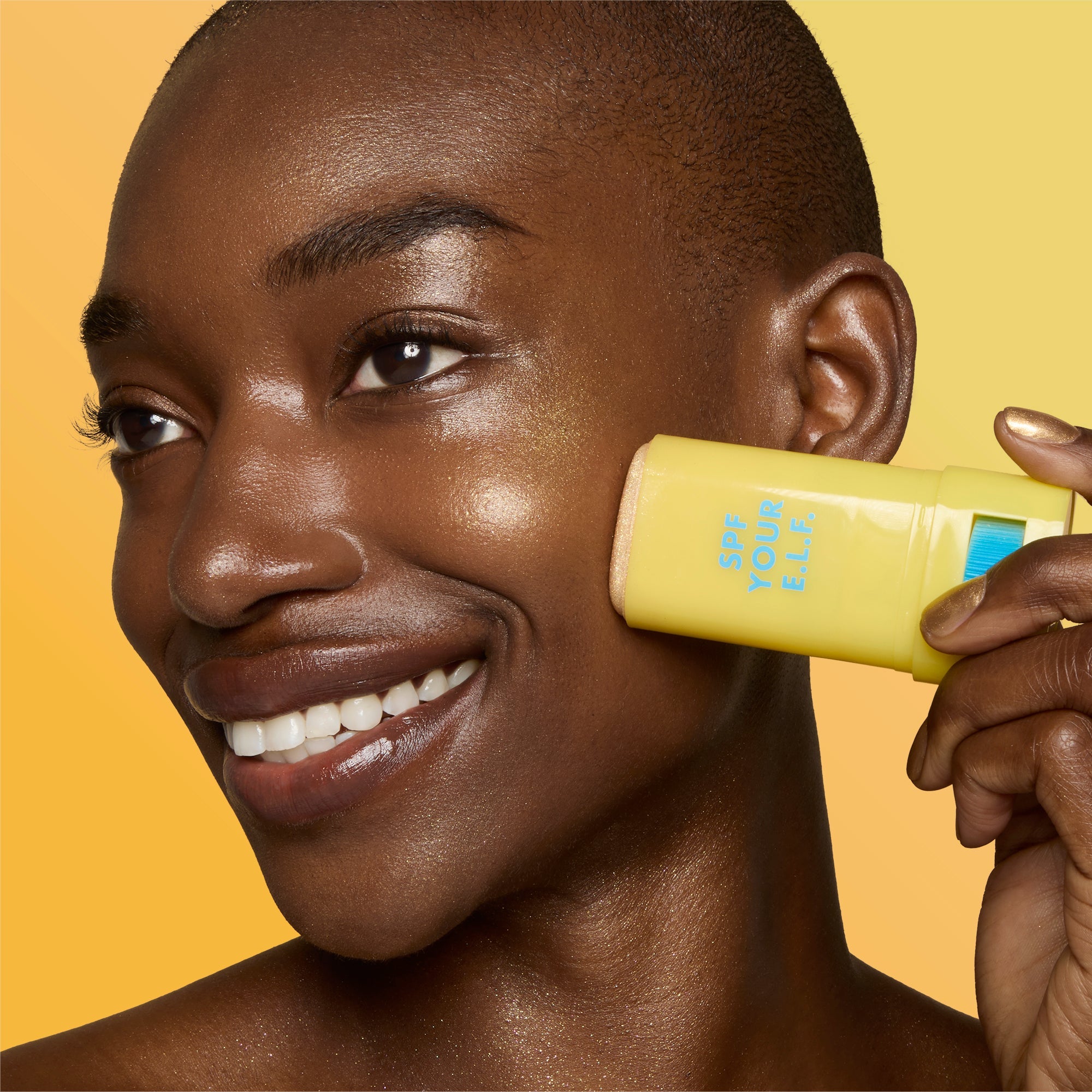 Close-up of a woman applying Invisi-Stick Glitz SPF 50 broad-spectrum sunscreen - Deep skin tone
