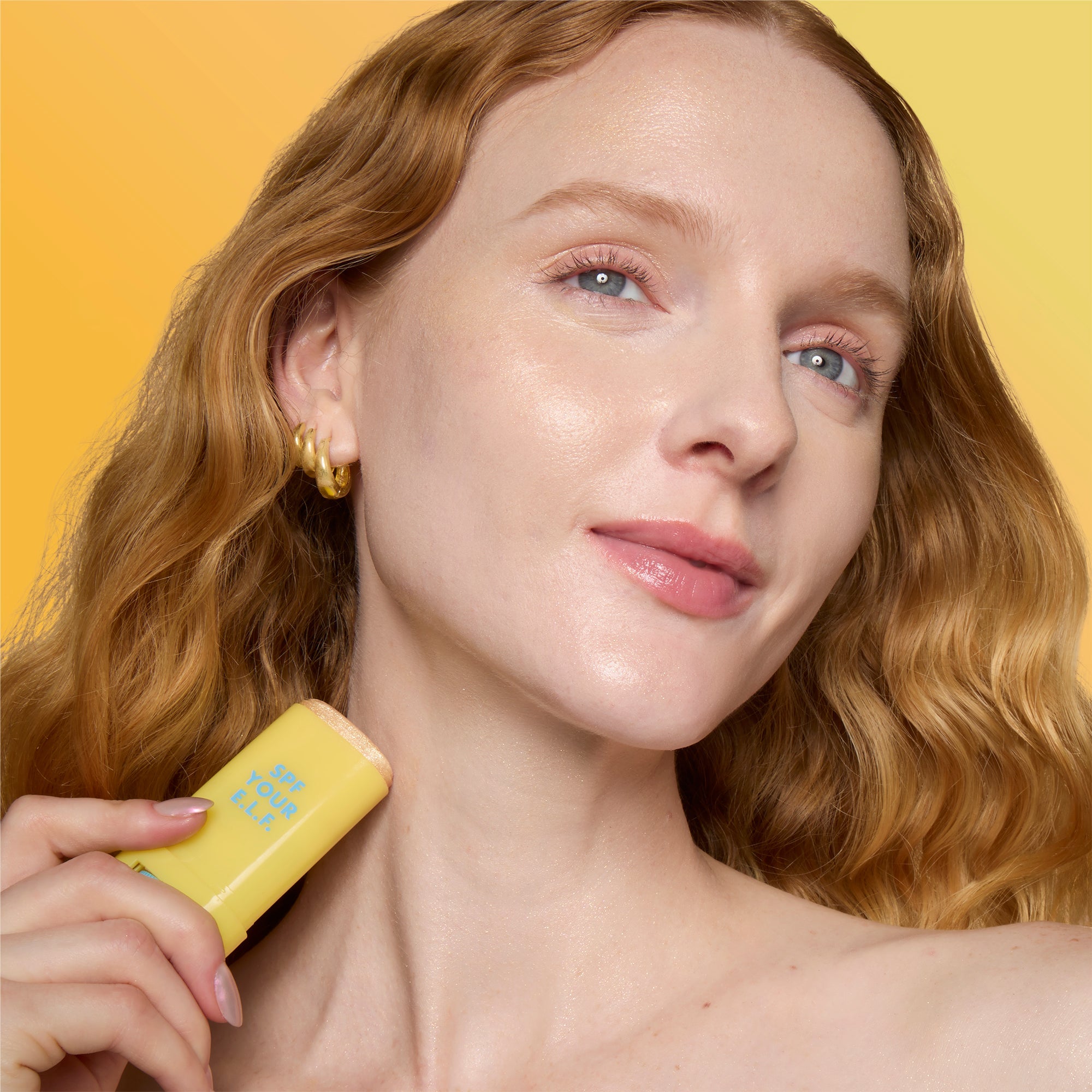 Woman applying Suntouchable Invisi-Stick Glitz SPF 50 Broad-Spectrum Sunscreen