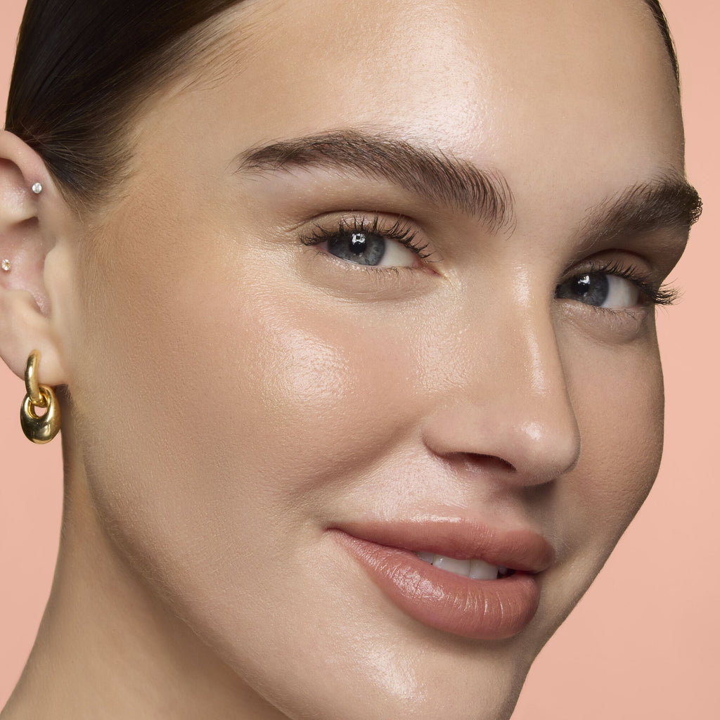 Close-up of a woman's face wearing Soft Glam Cream Bronzer in the shade of Fair